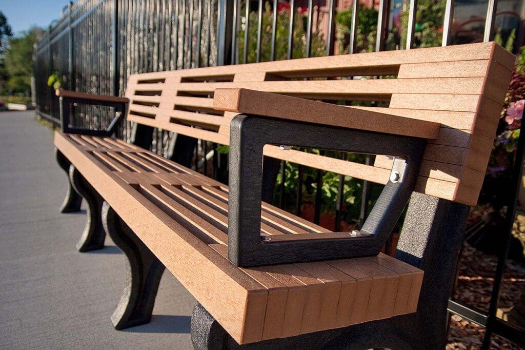 Close-up shot of Elite 8ft Backed Bench with arms placed at the Lansing Market